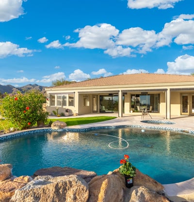 Scottsdale backyard featuring spa, pool, and expansive patio space with desert views, perfect for entertaining and relaxation.