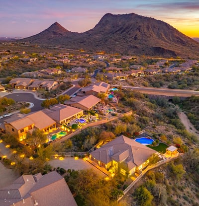 Scottsdale aerial showing the neighborhood at sunset with desert landscaping, homes, and warm evening lighting.