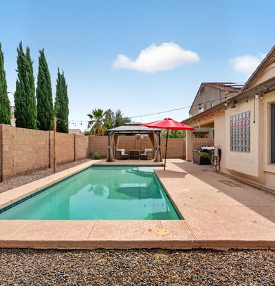 Inviting backyard with pool and low-maintenance design. Perfect for cooling off and entertaining in this Casa Grande home.
