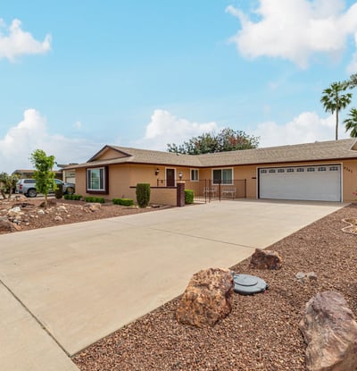 Side angle highlighting the home s structure, landscaping, and spacious lot. Located in Sun City, this property offers low-maintenance outdoor living.