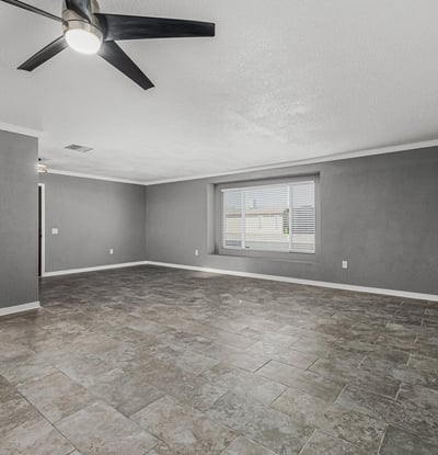 Open living room with natural light, neutral tones, and updated finishes. This Sun City home is move-in ready with a functional layout.