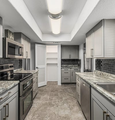 Efficient galley kitchen with ample cabinetry, modern lighting, and upgraded finishes. This Sun City home offers a practical layout for daily living.