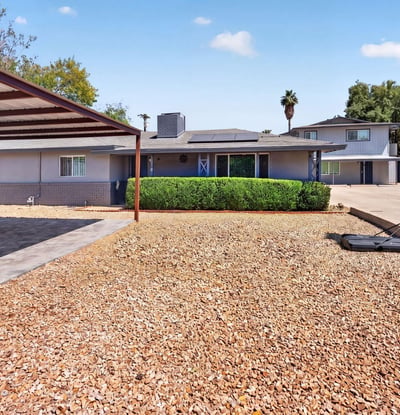 Durable paver parking under a covered structure provides style and practicality for this upgraded Phoenix multi-unit property.