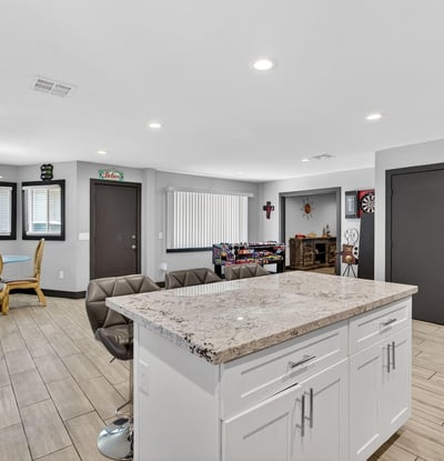 Kitchen island with bar seating connects seamlessly to living and dining areas, ideal for entertaining in this Phoenix home.