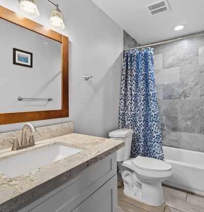 Functional full bathroom with tub-shower combo, updated tile, and clean finishes.
