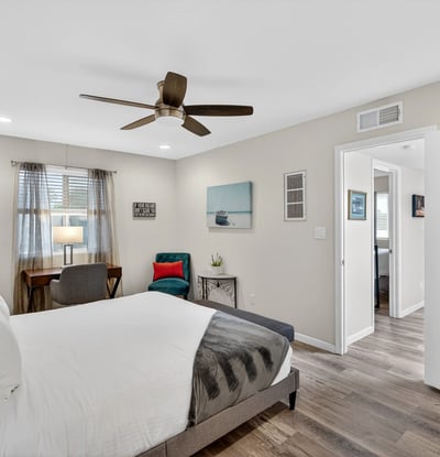 Comfortable Scottsdale bedroom with ceiling fan, updated flooring, and generous space for relaxing and unwinding.