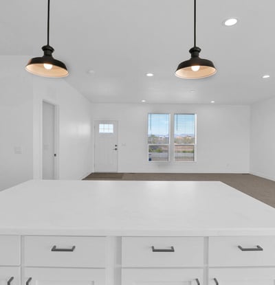 Spacious great room connected to the kitchen, creating a seamless flow throughout the home's main living areas. Recessed lighting, large windows, and an airy layout make this space ideal for family gatherings and entertaining.