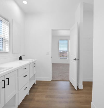 Spacious owner's bathroom offering dual vanities, modern fixtures, luxury flooring, and a bright open layout. The clean design and quality finishes add style and convenience to the primary suite.