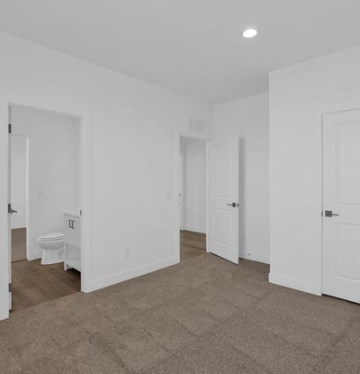 Well-sized bedroom featuring plush carpet, recessed lighting, and a clean modern design. A versatile space that can easily accommodate a variety of living arrangements and personal needs.