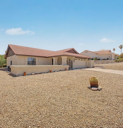 The generous lot and desert landscaping provide a peaceful setting with attractive neighborhood and mountain views. Enjoy the benefits of a low-maintenance property designed for comfortable Arizona living.