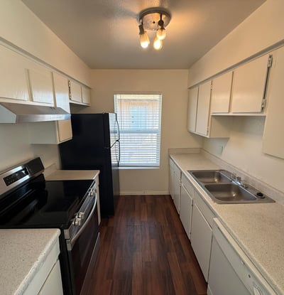 Functional galley-style kitchen featuring extensive cabinetry, generous counter space, and modern appliances. Designed for convenience, this space supports both everyday cooking and efficient organization.