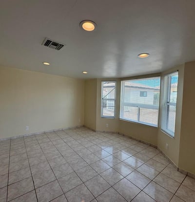Charming flex room enhanced by attractive bay windows that create a bright and welcoming atmosphere. Perfect for a home office, sitting room, hobby space, or additional bedroom, this versatile area offers endless possibilities.