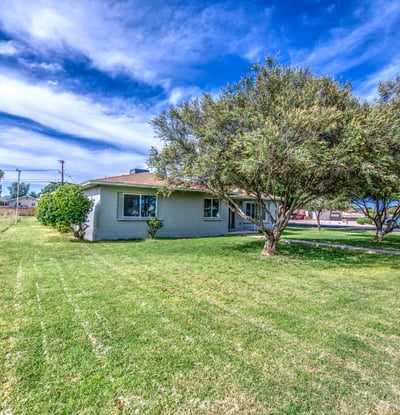 This generous front lawn offers beautiful green space, mature landscaping, and a welcoming approach that enhances the home's attractive exterior and neighborhood appeal.