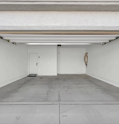 A clean and spacious attached two-car garage provides room for vehicles, storage, recreational equipment, and convenient access into the home.