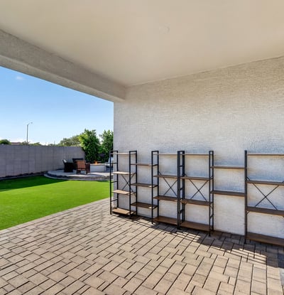 Enjoy shaded outdoor living beneath the covered patio while overlooking the beautifully landscaped backyard with low-maintenance artificial turf and entertaining spaces.