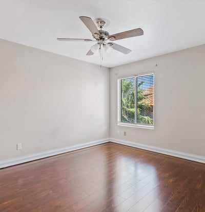 Large windows, wood flooring, and a ceiling fan make this upstairs bedroom bright, comfortable, and move-in ready. An excellent space for guests, family, or a home office.