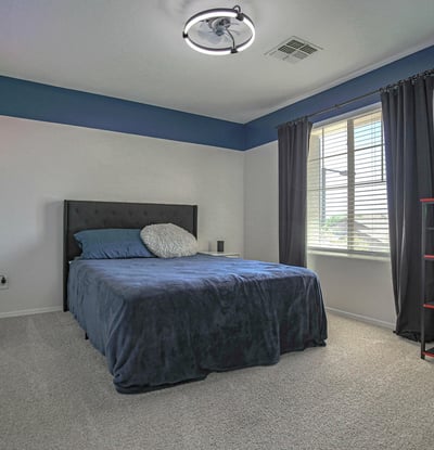 Inviting bedroom featuring plush carpeting, abundant natural light, and ample floor space for comfortable living. A flexible room suited for family, guests, or remote work.