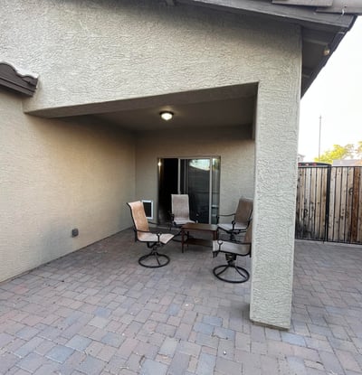 Covered patio creates the perfect shaded outdoor retreat for dining, entertaining, or enjoying quiet evenings while overlooking the spacious backyard.