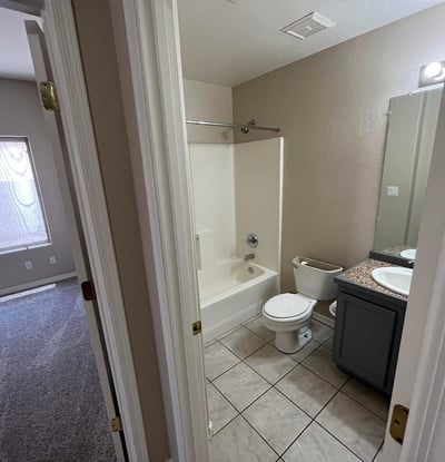 Clean and functional, this full bathroom offers a tub and shower combination, updated vanity, tile flooring, and a practical layout for family and guests.