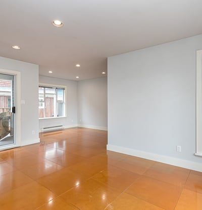 Spacious open-concept living area with natural light and access to a private outdoor balcony.