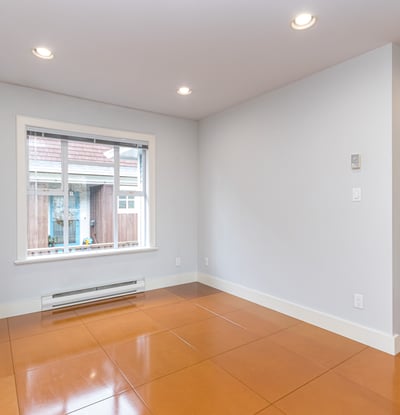 Bright and open space featuring large windows, perfect for personalizing as a cozy living area or studio.