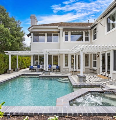 Discover a spacious outdoor oasis featuring a refreshing pool, spa, and ample lounging areas for relaxation.
