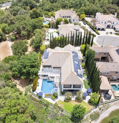 Stunning aerial view showcasing a spacious property with luxurious outdoor amenities and lush landscaping.