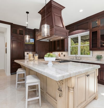 Discover a stunning kitchen featuring rich cabinetry, a spacious island, and modern appliances, perfect for entertaining.