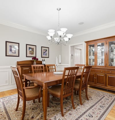 Elegant formal dining room with hardwood floors, detailed wainscoting, crown molding, and room to gather comfortably for holidays, dinner parties, and everyday celebrations.