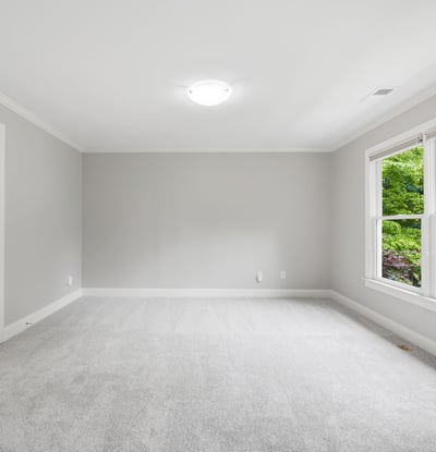 Spacious room with large windows offering natural light, perfect for customization and personal touches.