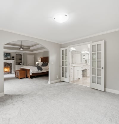 Spacious master suite featuring a cozy ambiance, private bathroom, and direct access to a serene living area.