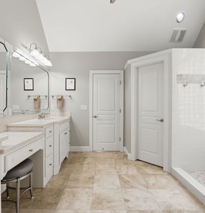 Spacious bathroom featuring dual vanities, modern fixtures, and a large walk-in shower for ultimate convenience.