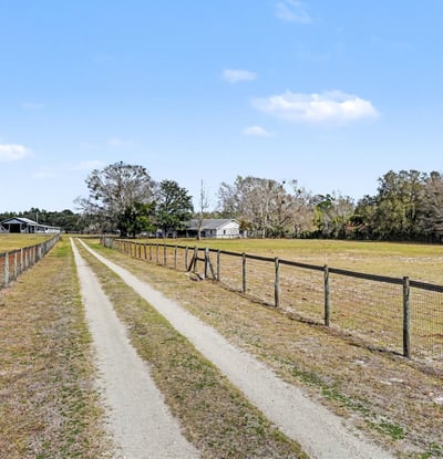 The private driveway boasts a solar-powered gate! Solar powered lighting lights the entry after dark.