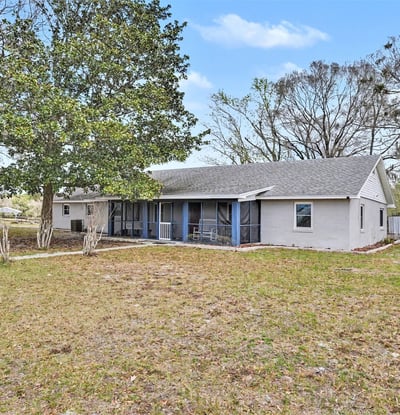 The front porch looks out across a picturesque field with mature trees, where you'll relax at the end of the day, soaking in the suns final rays. This photo also includes the southwest corner of the house. The sun rises behind the house, just off the Bonus Room and back deck. An added feature of the front porch sitting area is the screen enclosure along with the newly replaced screen door.