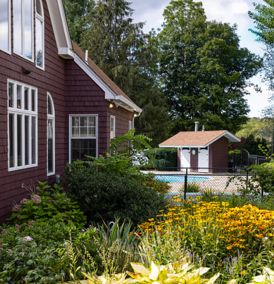 This inviting home features a lush garden, a private pool area, and picturesque outdoor views.