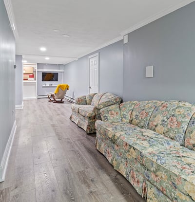 Bright and spacious lower level featuring a cozy seating area and convenient access to entertainment options.