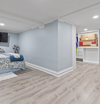 Spacious basement retreat featuring dual TVs, ample storage, and a cozy atmosphere for relaxation.