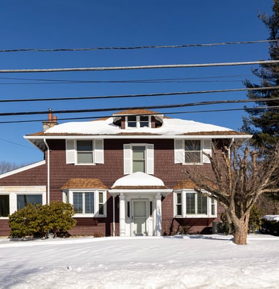 Spacious two-story home with ample outdoor space, located in a peaceful, snow-covered neighborhood.