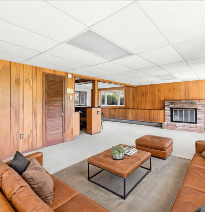 Spacious living area featuring large windows and a cozy fireplace, perfect for family gatherings and relaxation.