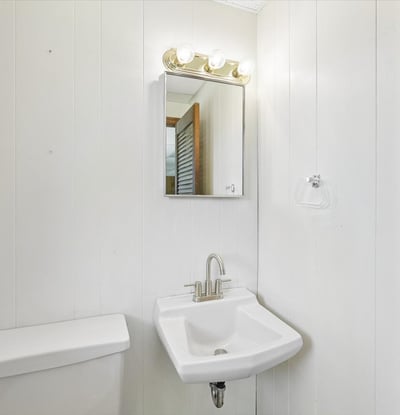 Modern half-bath featuring sleek fixtures and clean lines, perfect for maximizing space and functionality.