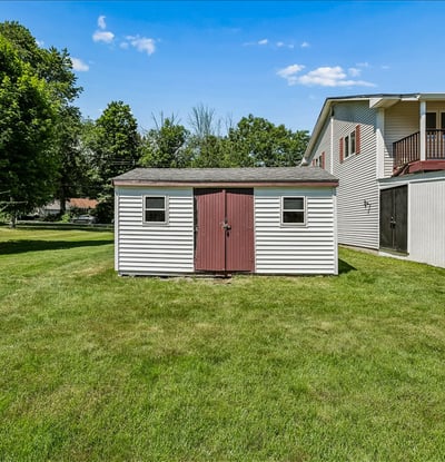Spacious backyard featuring a practical storage shed, perfect for keeping tools and outdoor equipment organized.