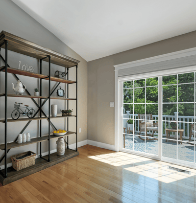 Bright living space featuring a modern open layout and large sliding doors leading to a private deck.