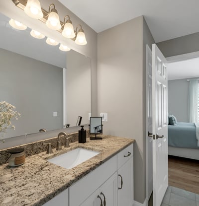 Contemporary bathroom featuring modern fixtures and a clean, open layout, seamlessly connecting to the adjacent bedroom.