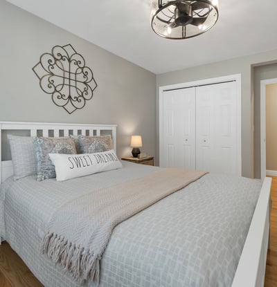 This cozy bedroom features modern decor, ample storage, and easy access to an en-suite bathroom.