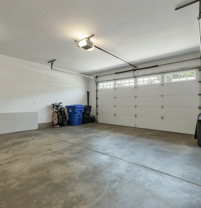Spacious garage with ample room for storage and parking, featuring a modern overhead door.