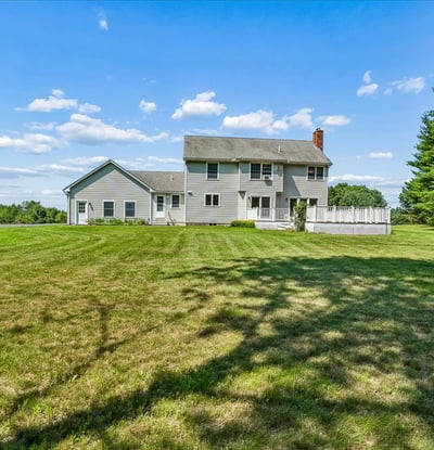 Spacious home on a generous lot, surrounded by greenery and featuring ample outdoor living space.