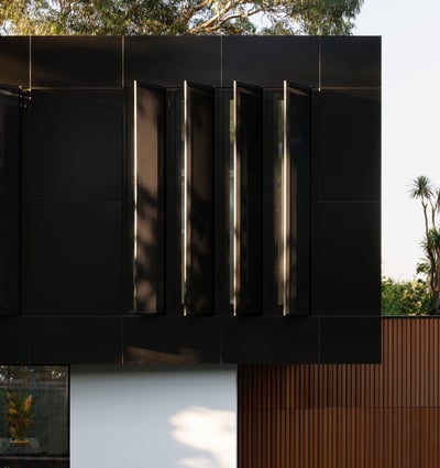 Contemporary architectural design featuring sleek black panels, offering a modern aesthetic and inviting outdoor space.