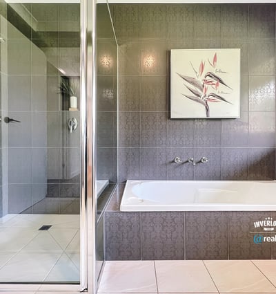 Spacious bathroom featuring a double vanity, modern shower, and relaxing bathtub for ultimate comfort.