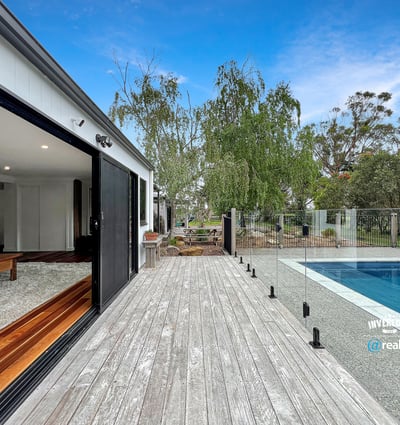 Modern home featuring open spaces, seamless indoor-outdoor flow, and a refreshing pool set amidst nature.