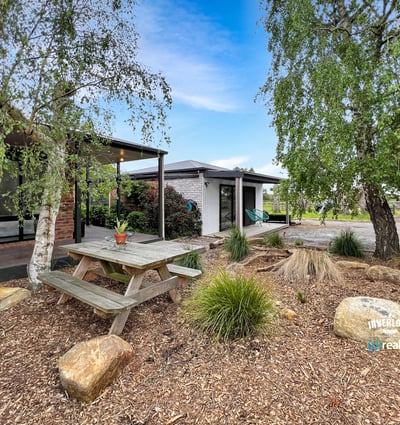 Discover a unique outdoor space featuring a picnic area surrounded by natural landscaping and modern amenities.